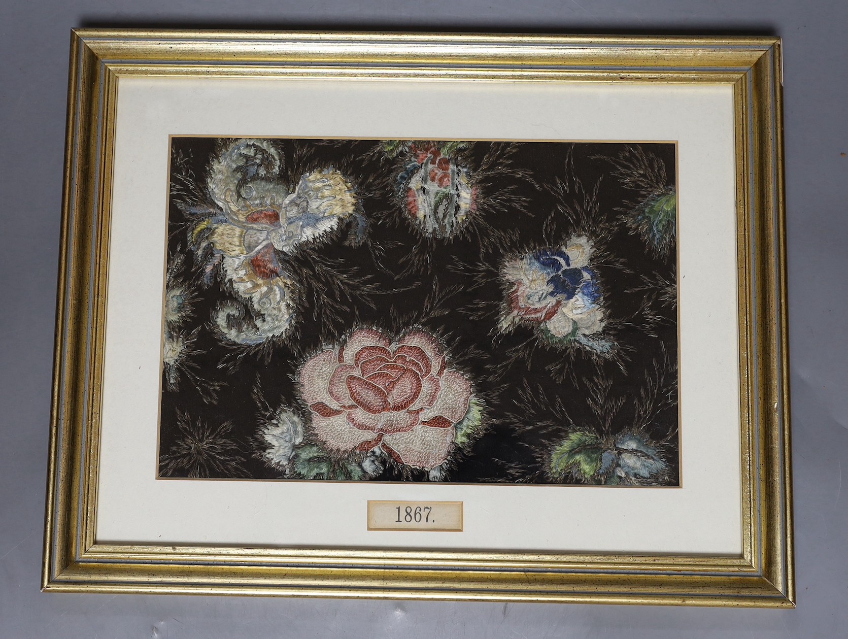 Framed floral silk embroidery, the mount dated 1867